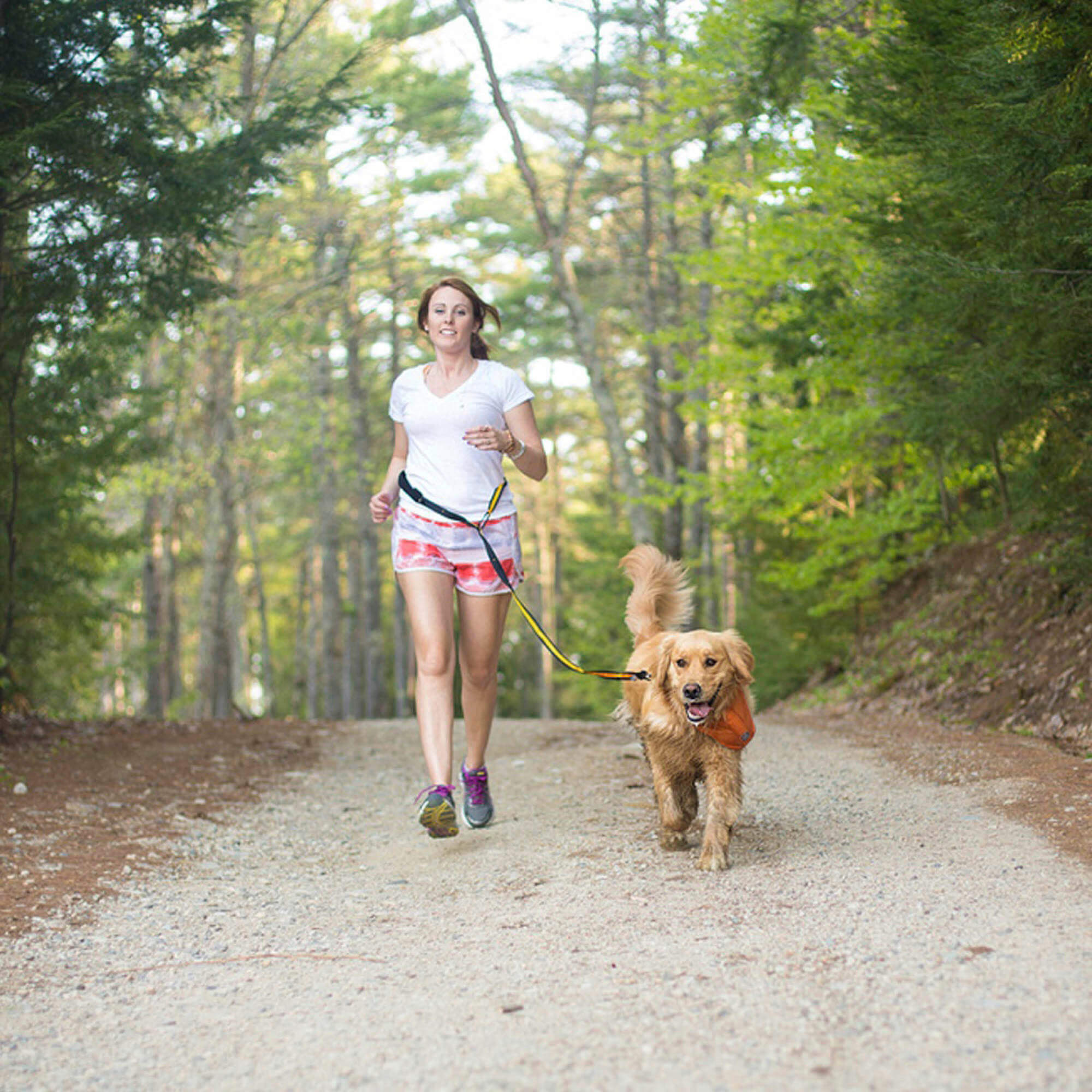woman running with her dog on the kurgo quantum dog leash