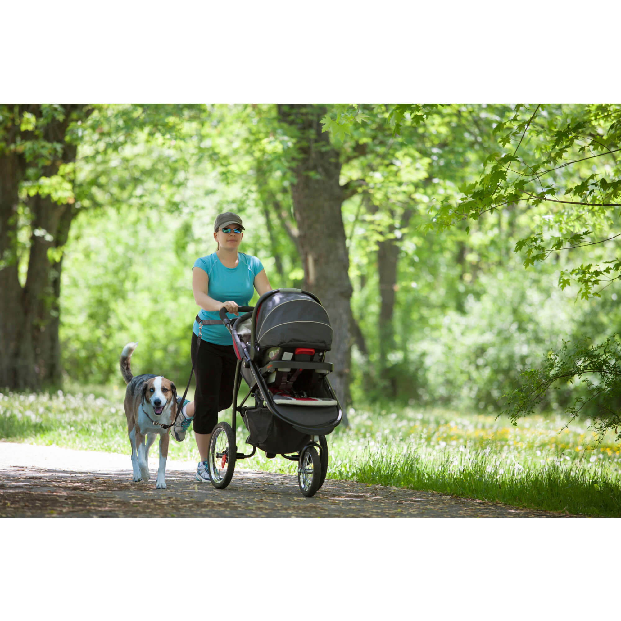Lady jogging with dog and stroller using petsafe hands free leash